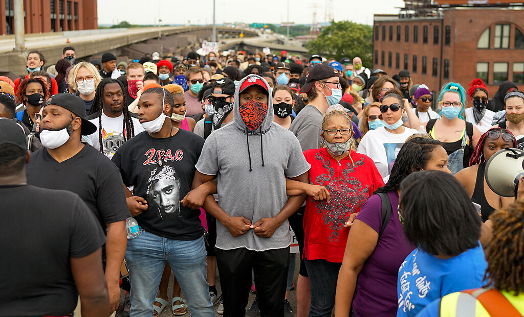 The group 'Expect Us' leads a peaceful protest Monday from St. Louis City Hall to the Gateway Arch and then to I-64